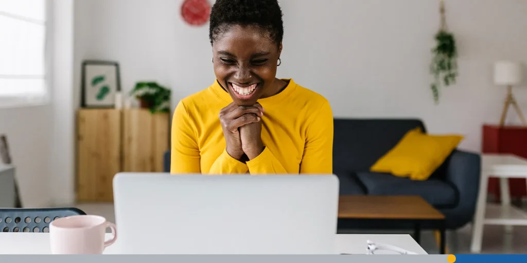 Young woman happy in front of her laptop.