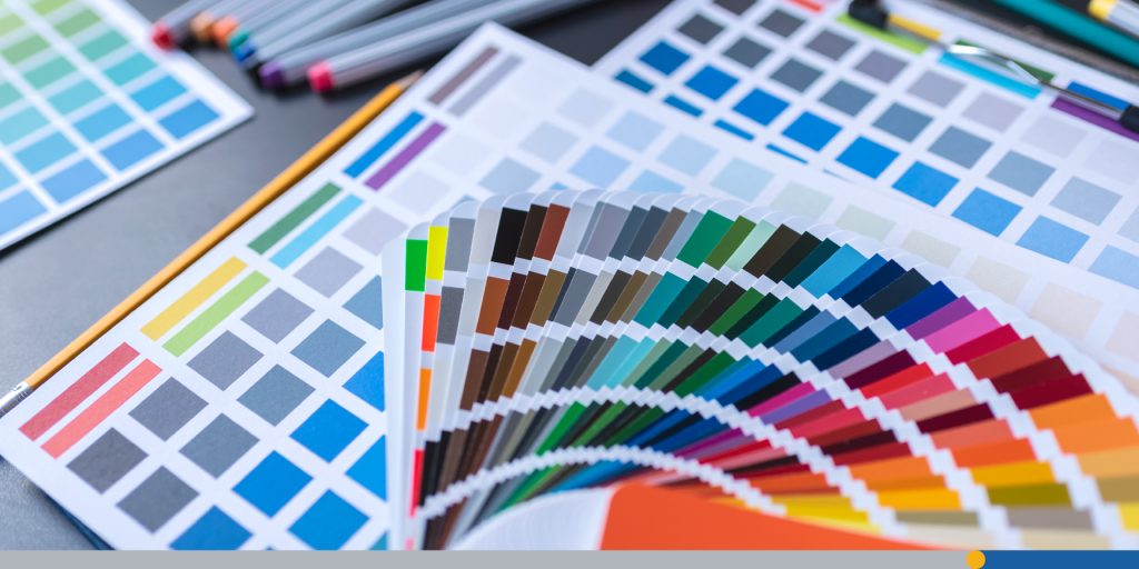 Graphic designers' color samples placed on the desk table.