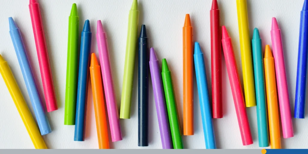 Row of brightly colored generic crayons on blank white paper, bright colors, flat, coloring, drawing.