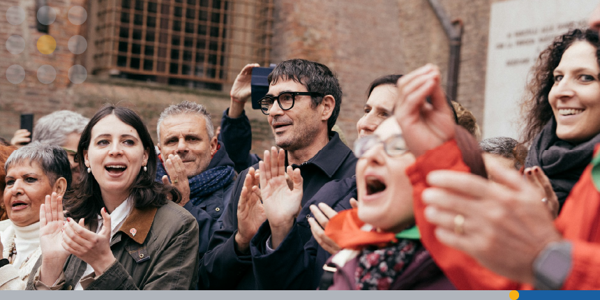 A group of people clapping and celebrating together.