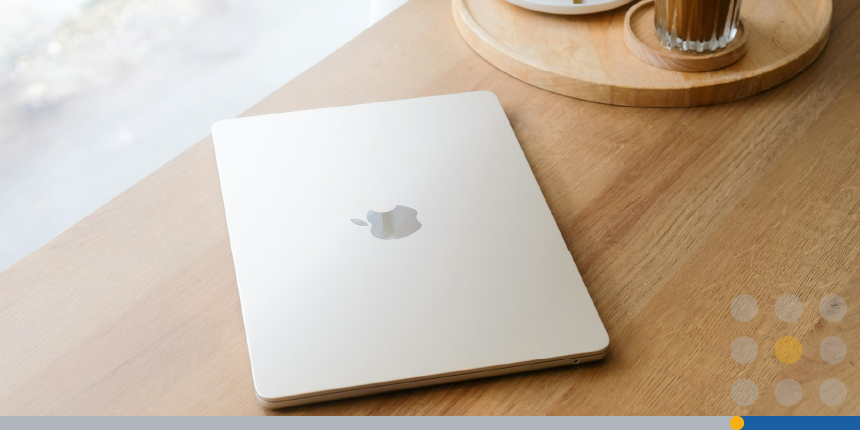 A laptop on a table in a coffee shop.