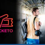 Man getting ready to board a train with a backpack and camera on his shoulder