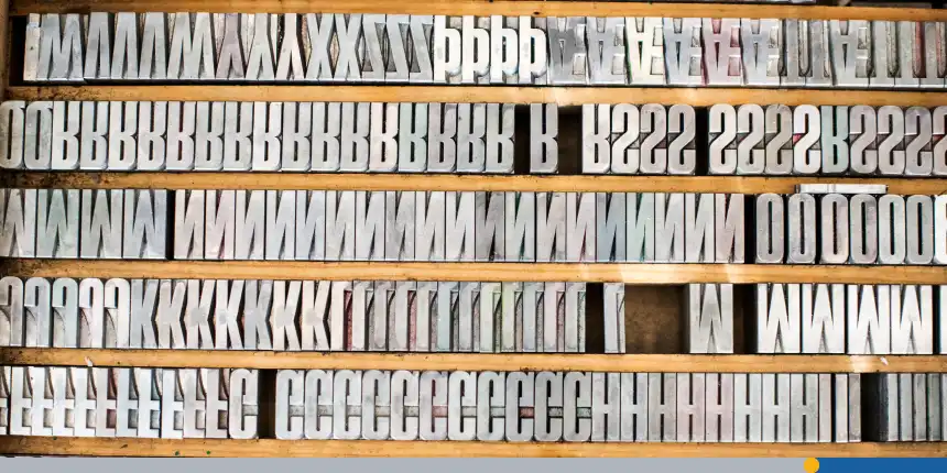 Shelves of silver letterpress letters in print workshop