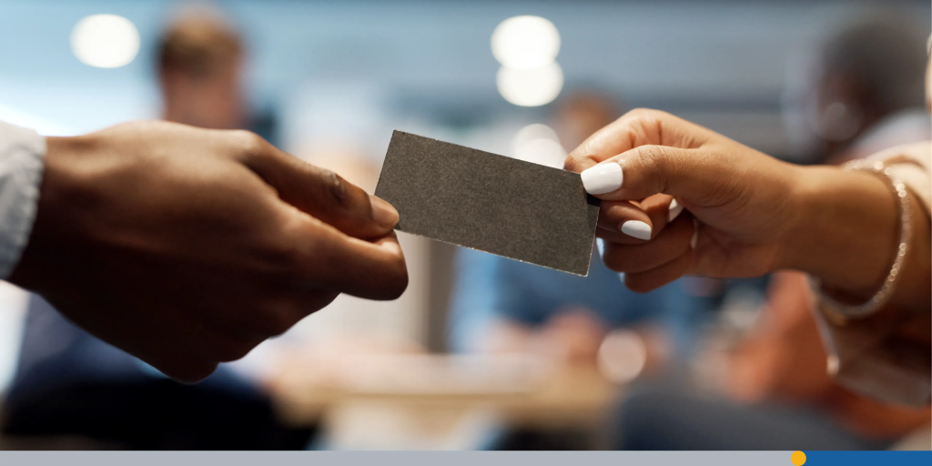 Shot of two businesspeople exchanging business cards at a conference