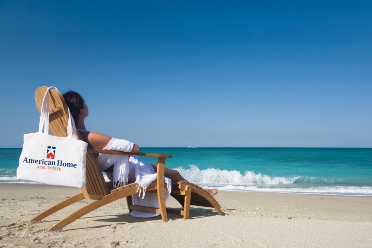 woman sitting in chair at the beach with custom tote bag