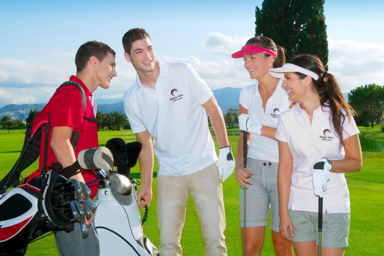 group of young adults golfing and wearing branded polos