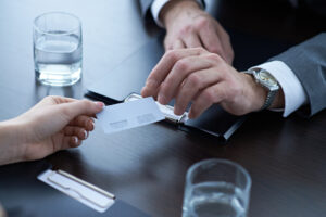 two people exchanging business cards