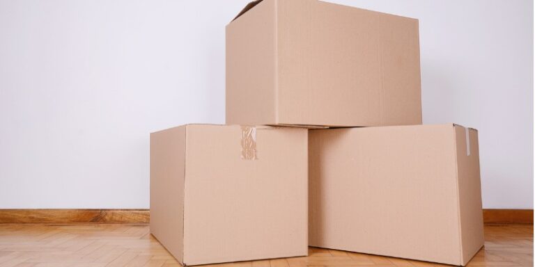 Stack of cardboard boxes in an empty room