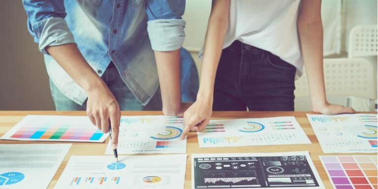 two people looking at colored graphs